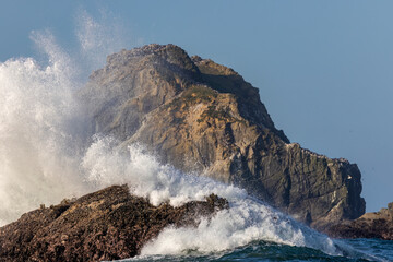 Surf hits at Face Rock at Bandon, Oregon, USA.