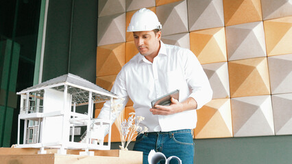 Professional caucasian architect engineer using tablet analysis house construction and checking...