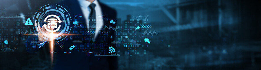 Backup: Data protection, disaster recovery, cloud storage, system recovery, information security, data recovery, redundancy, Businessman analyzes backup technological data.