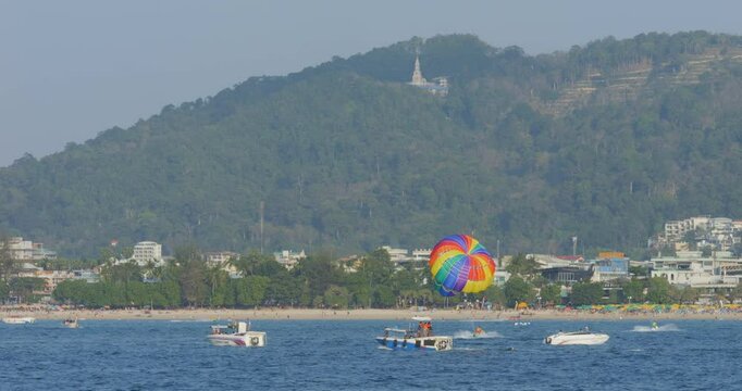 Tropical bay with tourists parasailing