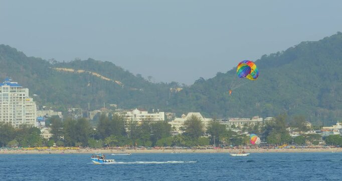 Tropical bay with tourists parasailing