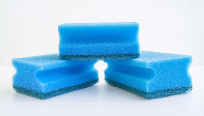Blue kitchen sponges for dishwashing on white background. Foam scrubber. Dish cleaning sponge.