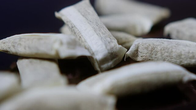 Snus nicotine tobacco close up, pack of tobacco for gum. unhealthy addiction. Man opening box with snus and taking one. 