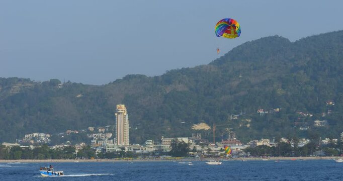 Tropical bay with tourists parasailing