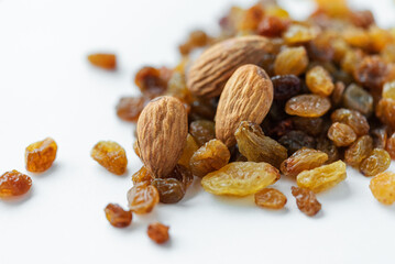 Appetizing almonds and sweet raisins on a light background. Vegetarian food, healthy sweets