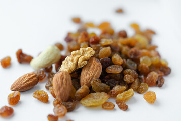 Vegetarian food, cashews, walnuts, almonds and appetizing raisins on a light background. Vegetarian food, natural sweets