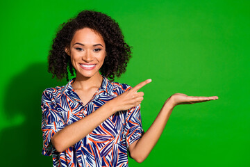 Photo of adorable pretty lady wear print shirt pointing finger showing arm empty space isolated...