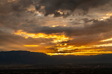 USA, New Mexico, Sandia Mountains. Cloudy sunrise over Albuquerque.