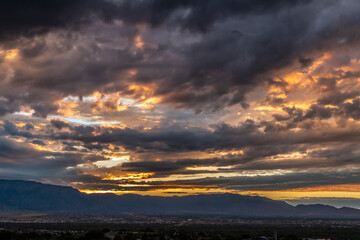 USA, New Mexico, Sandia Mountains. Cloudy sunrise over Albuquerque.