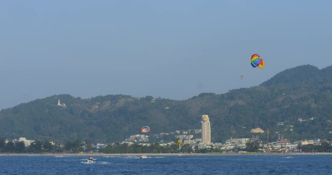 Tropical bay with tourists parasailing