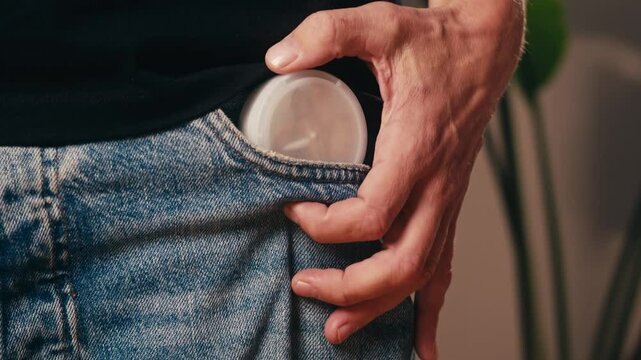 Snus nicotine tobacco close up, pack of tobacco for gum. unhealthy addiction. Man opening box with snus and taking one. 