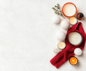 Relaxing spa setting with candles and red towel on white background