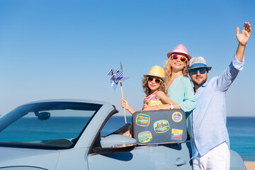 Happy family travel by car by the sea