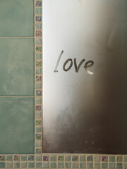 LOVE Written on a Foggy Bathroom Mirror with Mosaic Details