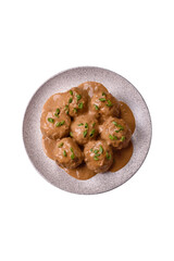 Meatballs with salt and spices in creamy caramel sauce