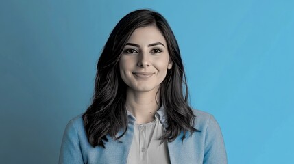 Fototapeta premium Smiling woman portrait, blue background, studio shot, headshot, professional profile picture