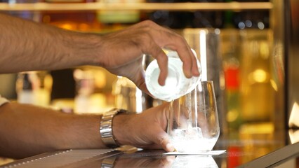 Closeup bartender hand in poring fresh soda gas texture into glass of drink advertisement serving customer at beverage bar counter luxury pub for welcome impression greeting guess service. Vinosity.