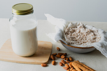 Making almond milk using cheesecloth and cinnamon sticks