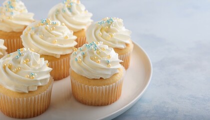 Six delicious vanilla cupcakes, topped with creamy frosting and pastel sprinkles.
