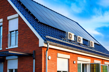 An air-source heat pump unit is situated outdoors in a contemporary Dutch home equipped with solar panels.