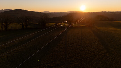 Power Lines at Sunset &ndash; Aerial View Over Rolling Hills in france