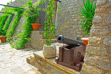 Streets of the old town of Budva with stone walls and cobblestones.