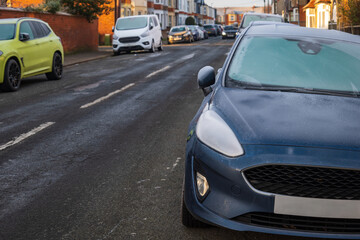 Frost snow covered british road and cars in england uk