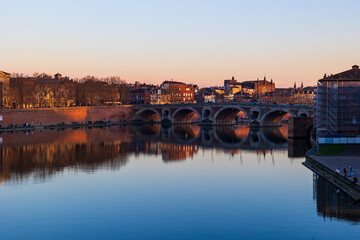 Fototapeta premium Pont Vieux Crossing the Garonne in Toulouse and Notre-Dame de la Dalbade Church at Sunset, Seen from the Opposite Bank