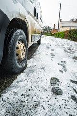 Frost snow covered british road and cars in england uk