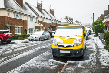 Frost snow covered british road and cars in england uk