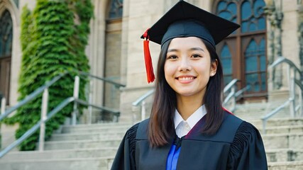 4k video of an Asian graduation student woman smiling.