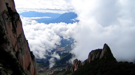 Clouds enveloping a breathtaking mountain vista during an early morning hike in a remote location filled with natural beauty and tranquility