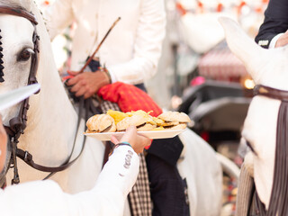 Fototapeta premium Riders on Horses Eating at Sevilla Fair