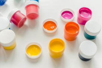 Jars of acrylic paint on a white background. Acrylic paint. Jars of gouache.