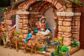 A close-up of a Catholic Christian creche with baby Jesus, Mary, and Joseph, depicting a peaceful...