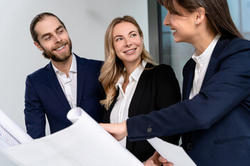 Fototapeta premium Young specialists in the office looking busy and involved