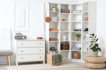 Stylish interior of light room with clothes and decor