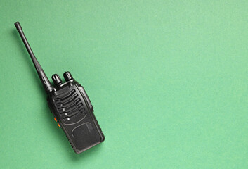 One walkie talkie on green background, top view. Space for text