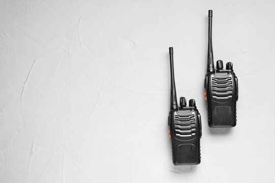 Walkie talkies on white table, top view. Space for text - Powered by Adobe