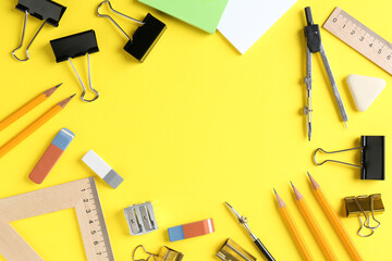 Flat lay composition with ruler and other stationery on yellow background, space for text