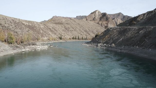 Calm flow of water in the river. Altai mountain landscape in autumn