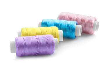 Spools of bright sewing threads isolated on white