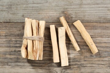 Palo santo sticks on wooden table, flat lay