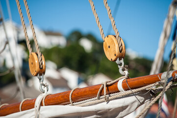 sailing pulley and ropes on wooden mast.