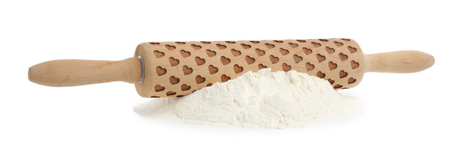 Patterned wooden rolling pin and pile of flour isolated on white
