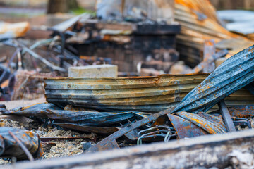 pile of twisted rusted metal debris from collapsed structure.