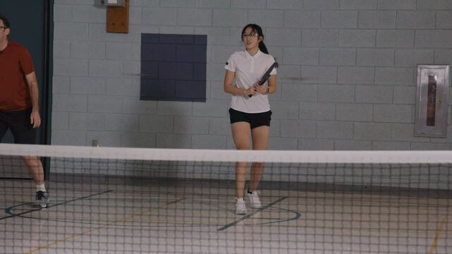 Female pickleball player big swing slow motion