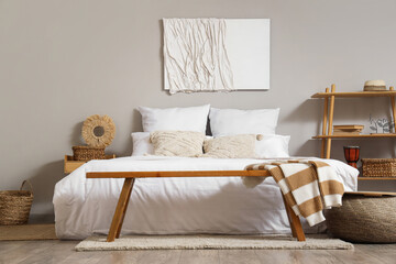 Stylish interior of bedroom with picture on wall