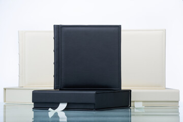 Wedding photobooks with boxes in white and black leather binding. Family album. Services of a...