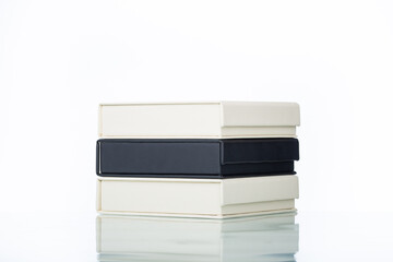 stack of photoook boxes. Wedding boxes of photobook in white and black leather binding. Wedding photo box, album family. cover of genuine leather. Services of a typography 